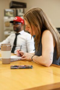 Director of Marketing Taking Notes – Morning Team Meeting and Strategic Planning - Ink & Arrow Marketing Co. Content Writing & Development Services by Ink & Arrow in Berwick, PA