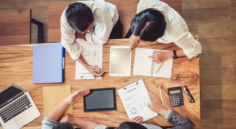 Ink & Arrow Marketing digital marketing metrics review - Ink & Arrow Marketing Co. A marketing team reviewing metrics and analytics to plan future projects, highlighting Ink & Arrow Marketing’s expertise in digital marketing and social media management.