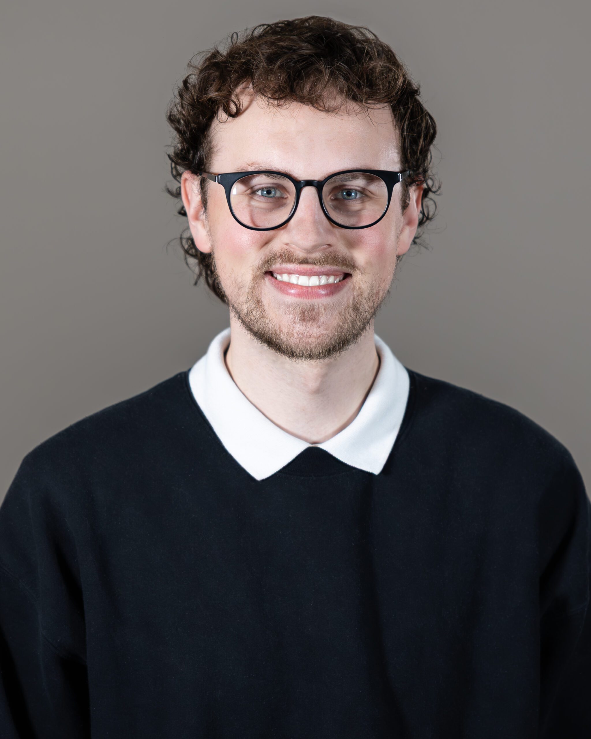Headshot of Nick Thompson, Head Videographer, smiling confidently with forward-looking inspiration and creative leadership